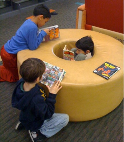 Three children are seated around one of the 