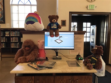Stuffies checking out spooky books.jpg